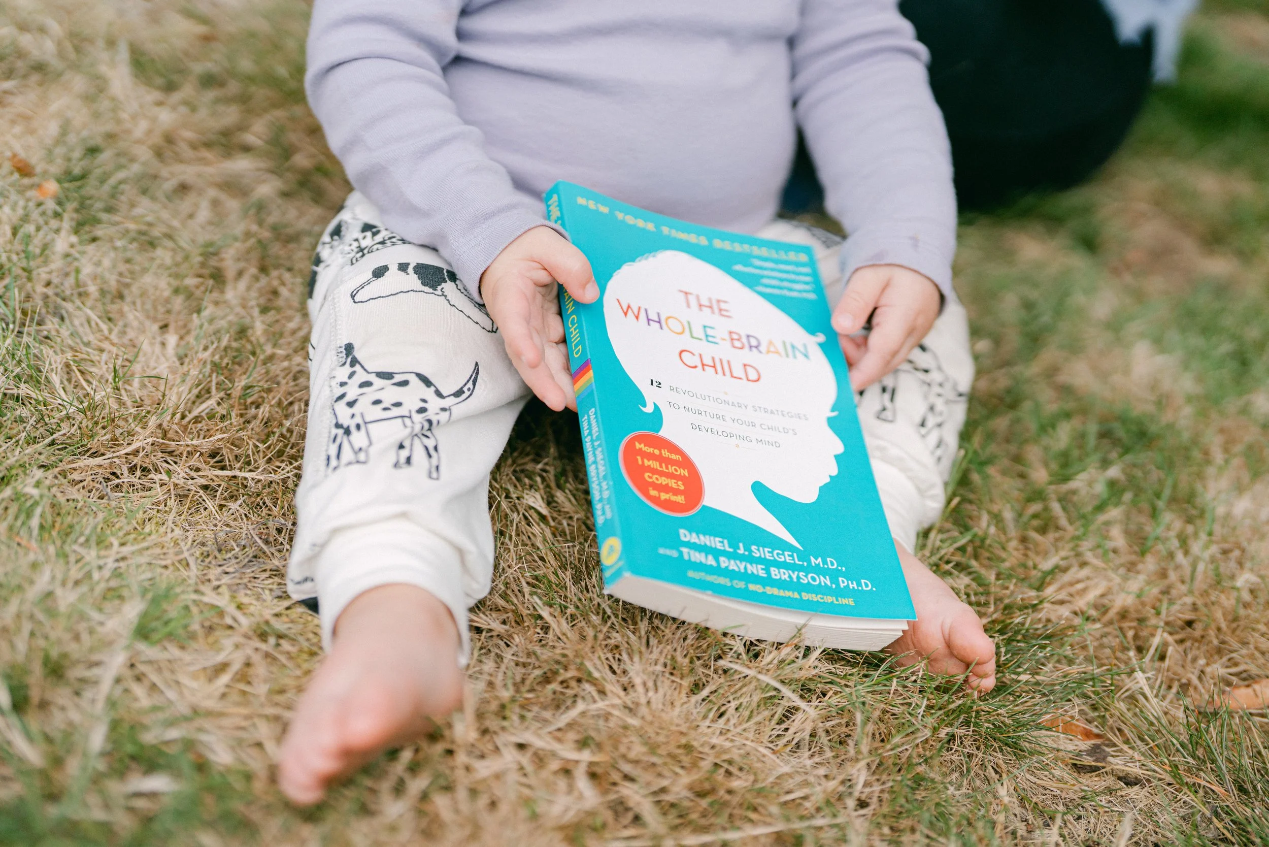 toddler with a book in their lap